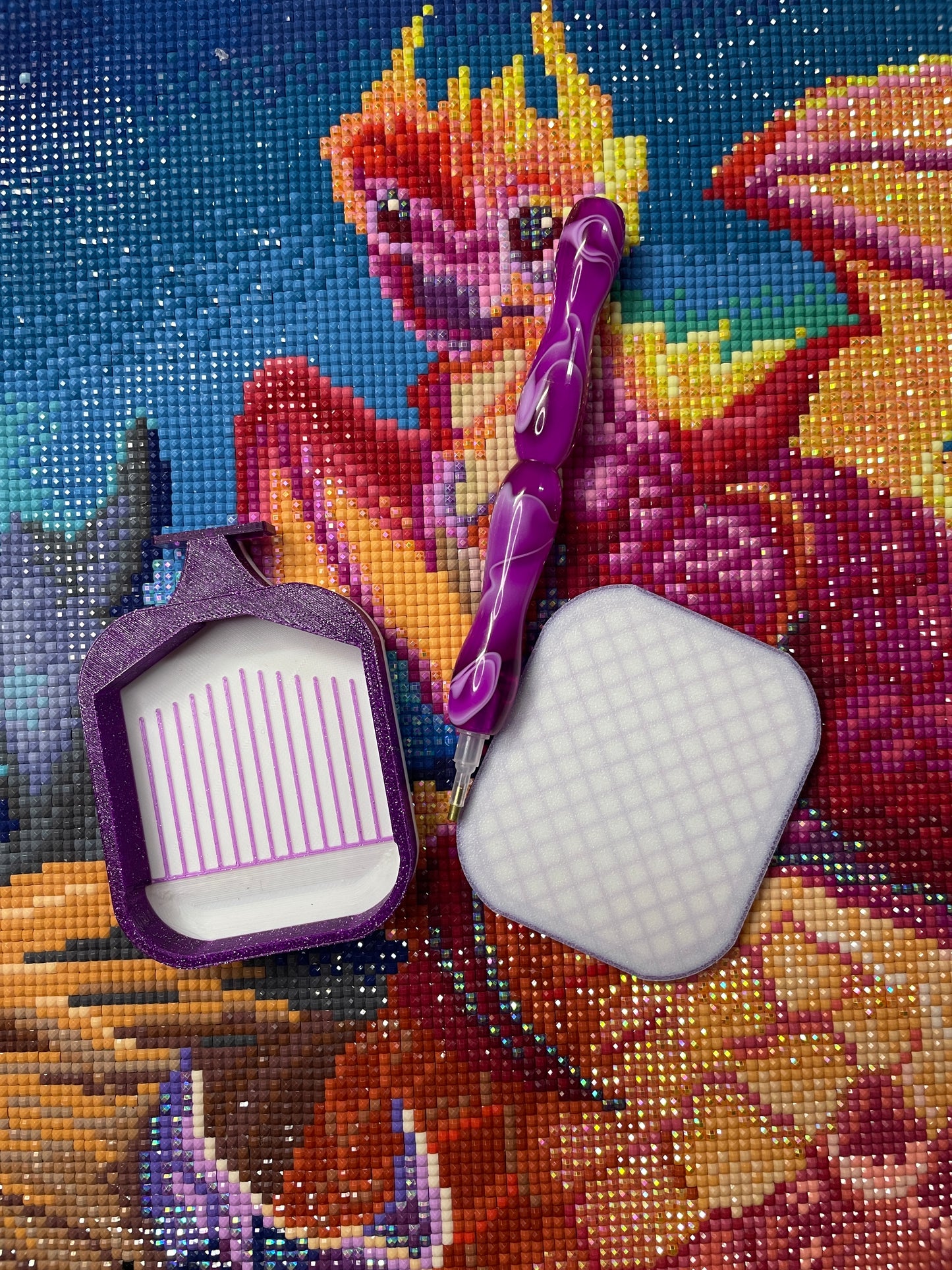 Purple and white small diamond painting tray set with matching pen on a vibrant phoenix-themed canvas background.