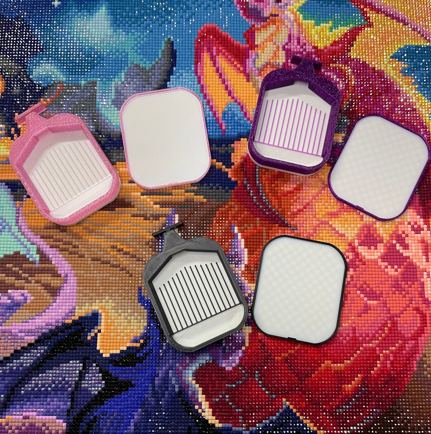 Deluxe 2 Phoenix Small Diamond Painting Trays in assorted colors with white lids and bases on colorful background.