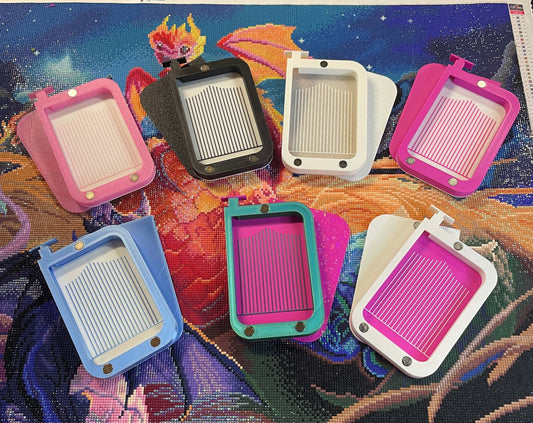 Colorful Magnetsaurus diamond art trays with magnetic lids on vibrant background.