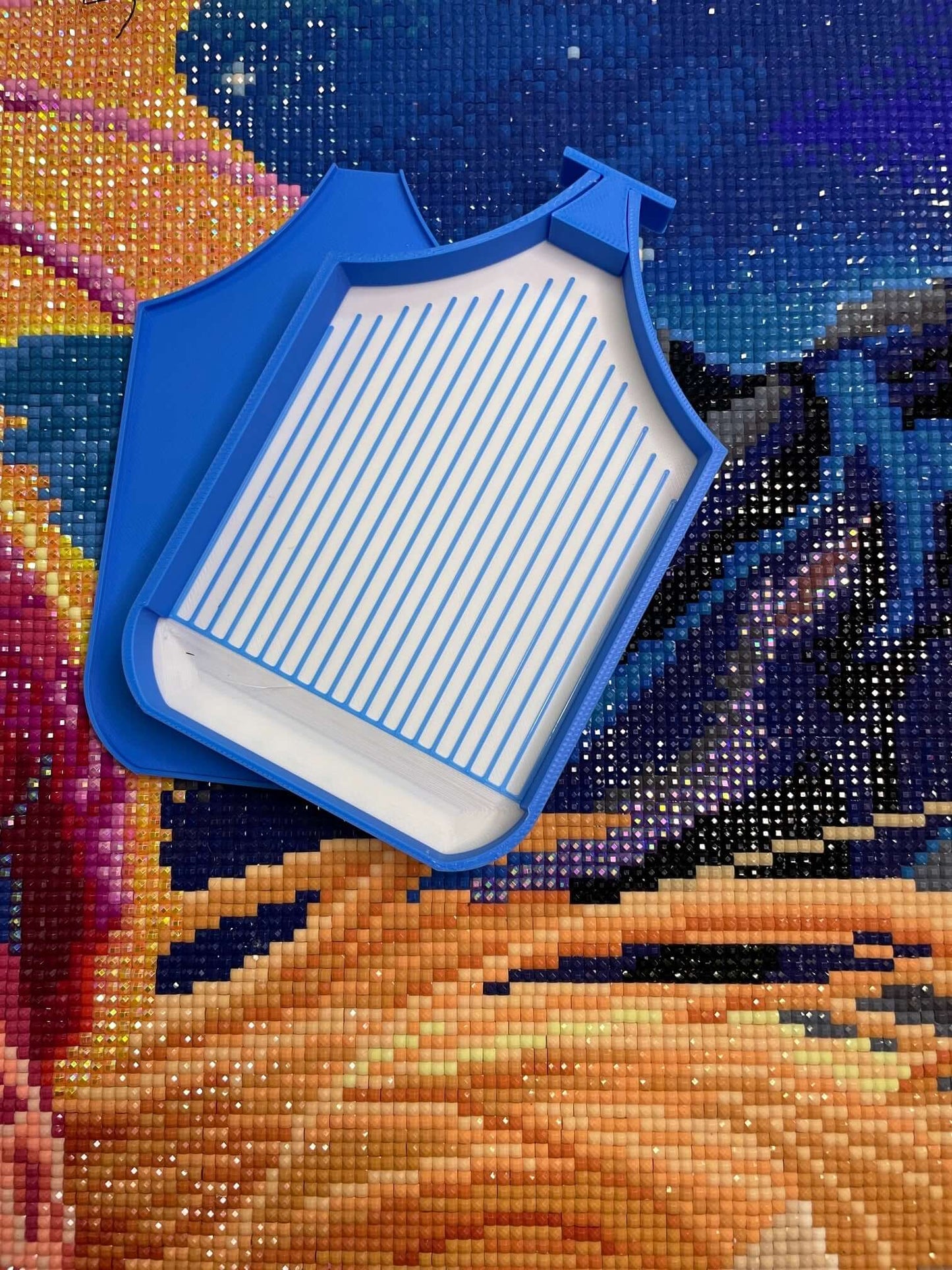 Blue Dragonling Tray with white belly on a colorful diamond art canvas.