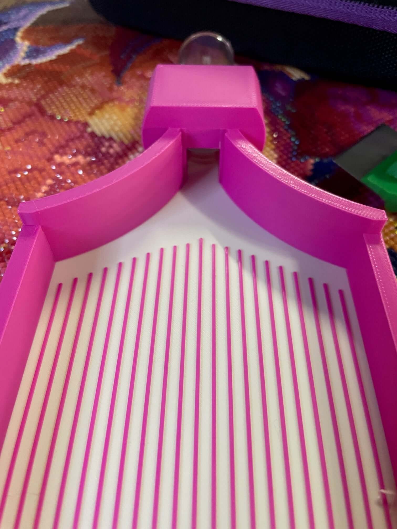 Pink and white Screw & Shake tray with high walls and slide stopper for drill container attachment.