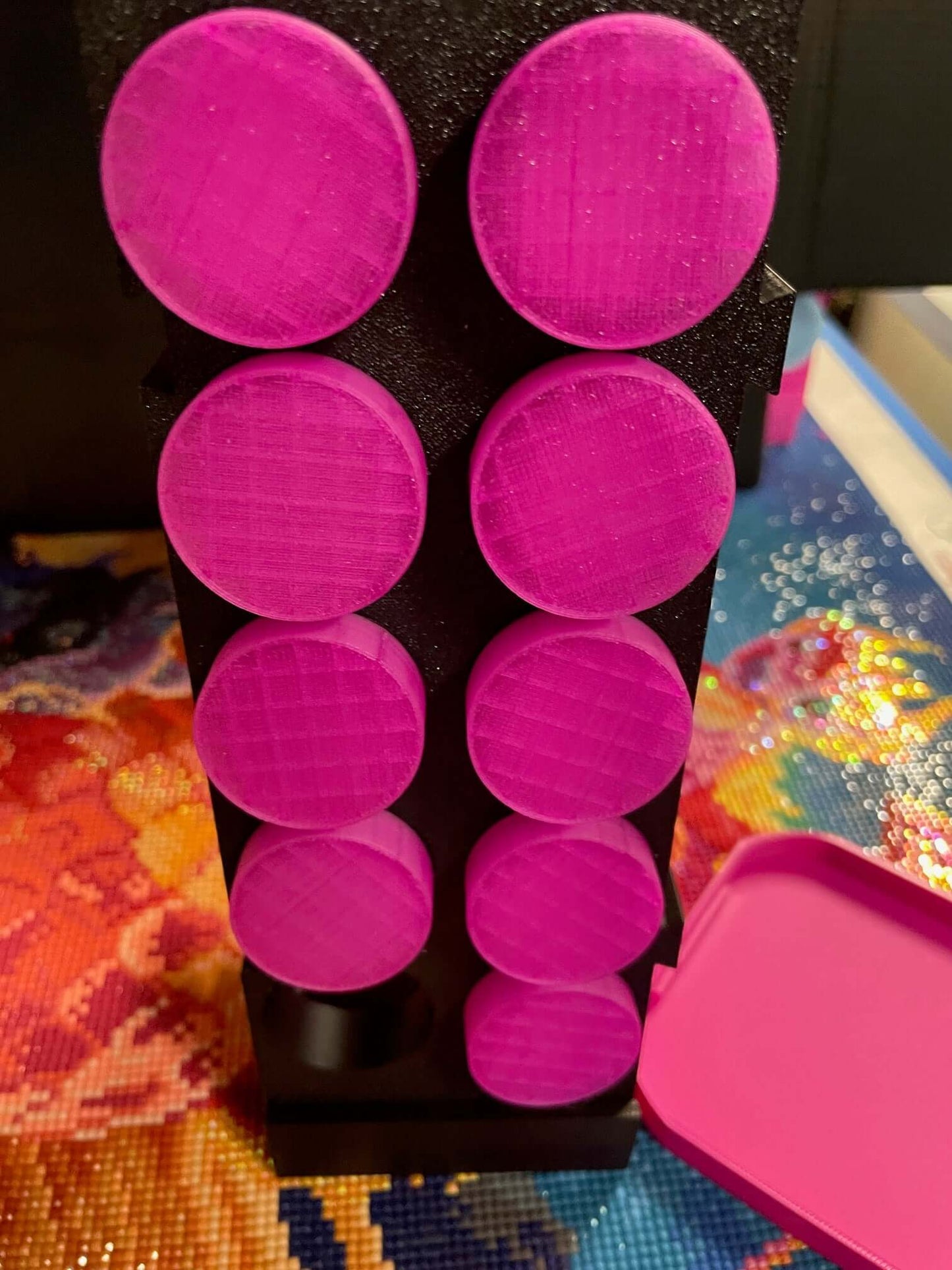 Pink Mist containers stacked on a black upright stand from the Screw & Shake Starter Kit.