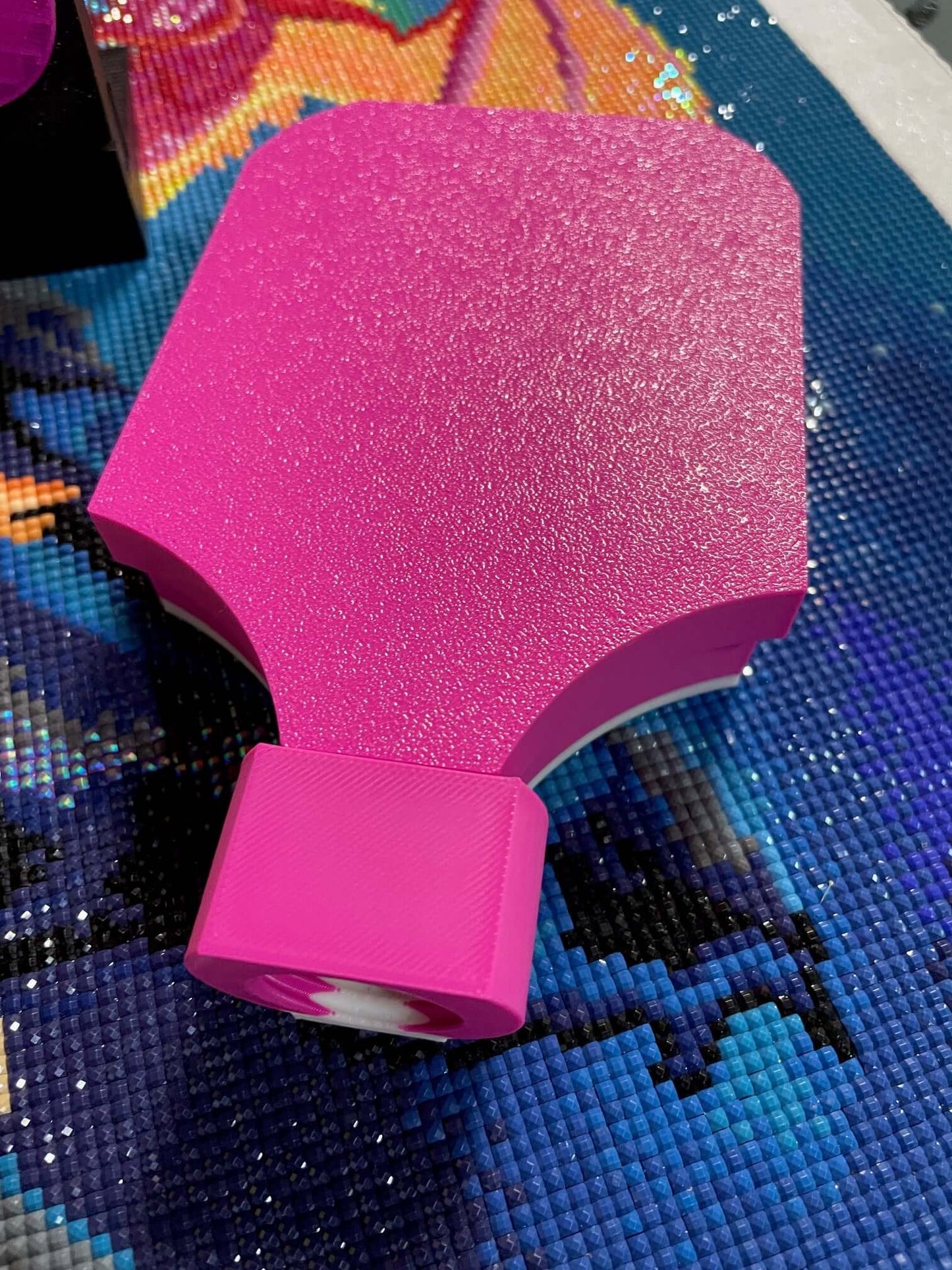 Pink Mist Screw and Shake container lid on textured surface.