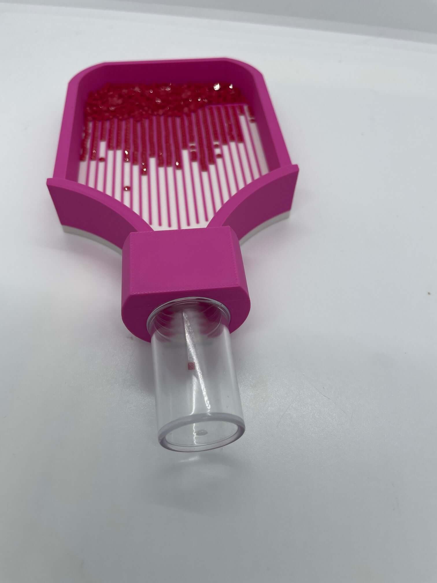 Pink Screw & Shake Tray with transparent drill container adaptor for organizing art supplies.