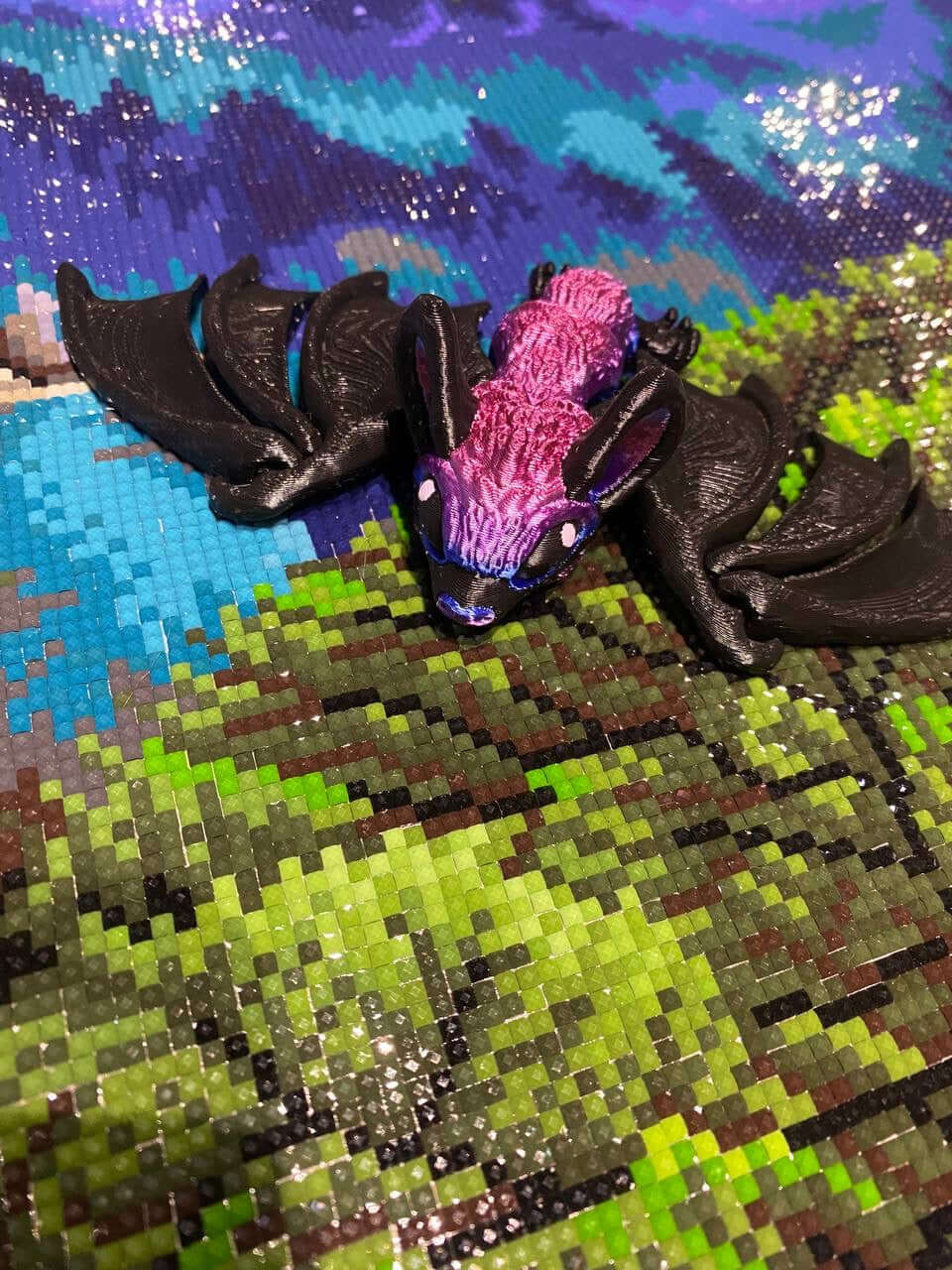 Vibrant purple and black Vampire Bat Painting Buddy on colorful diamond art canvas background.