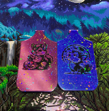Two colorful dragon Diamond Art trays with Halloween-themed designs featuring a werewolf pup and pumpkin, set against a scenic background.