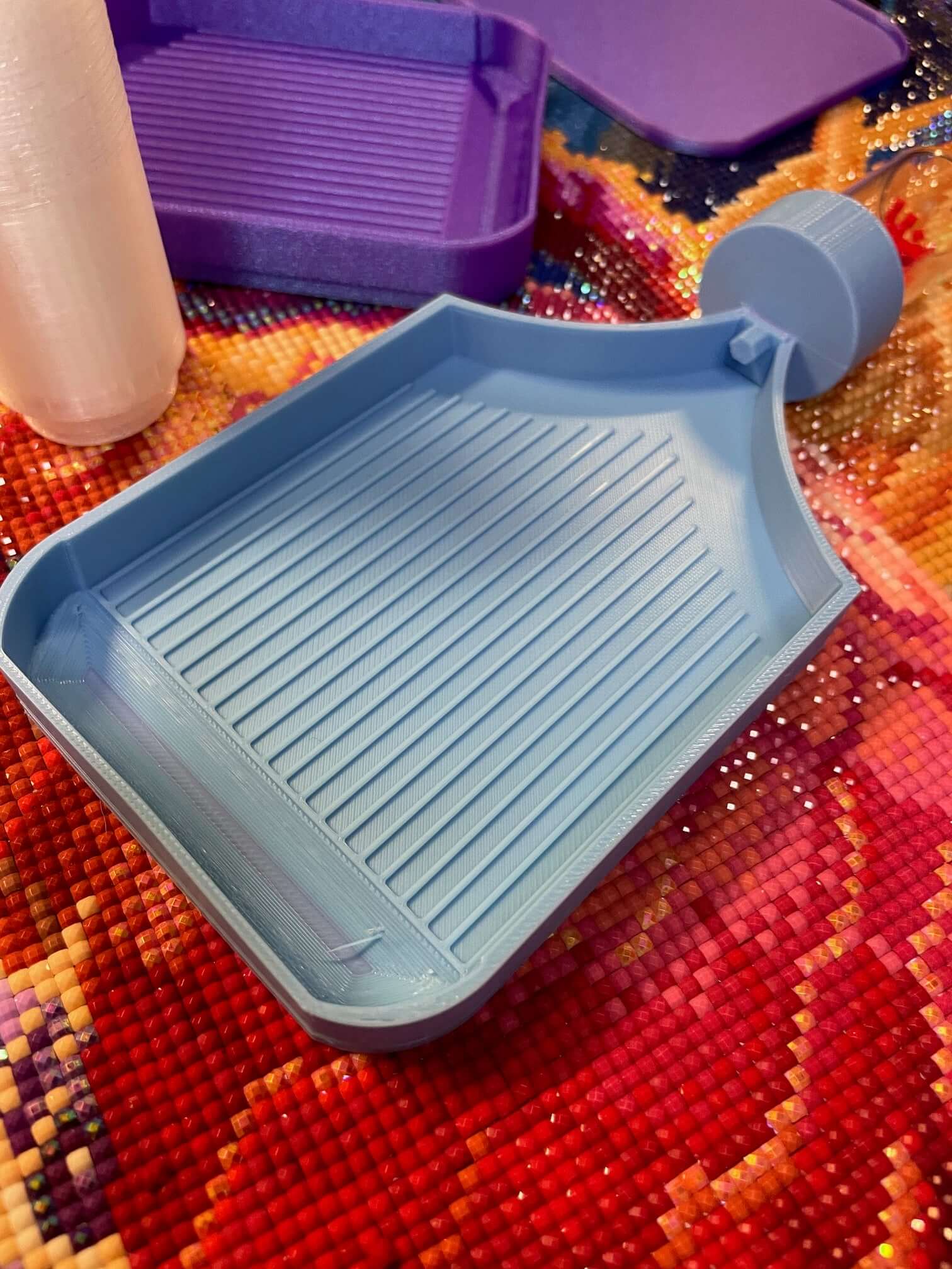 Light blue Dragonling Screw & Shake tray on colorful diamond art canvas with screw-in container option.