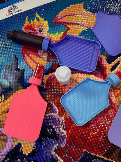 Colorful diamond art trays with screw-in containers on vibrant dragon-themed canvas background.