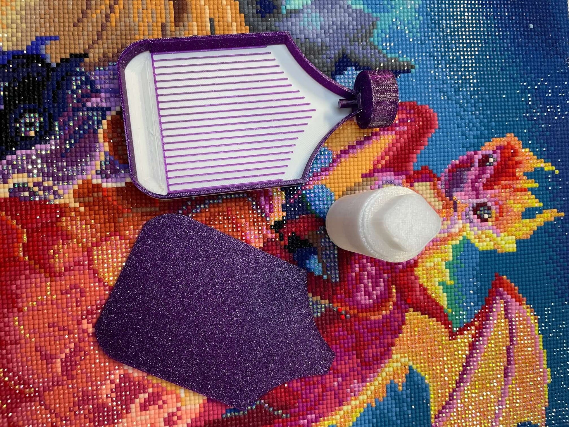 Dragonling Screw & Shake White Belly Diamond Art Tray with purple accents on colorful diamond art backdrop.