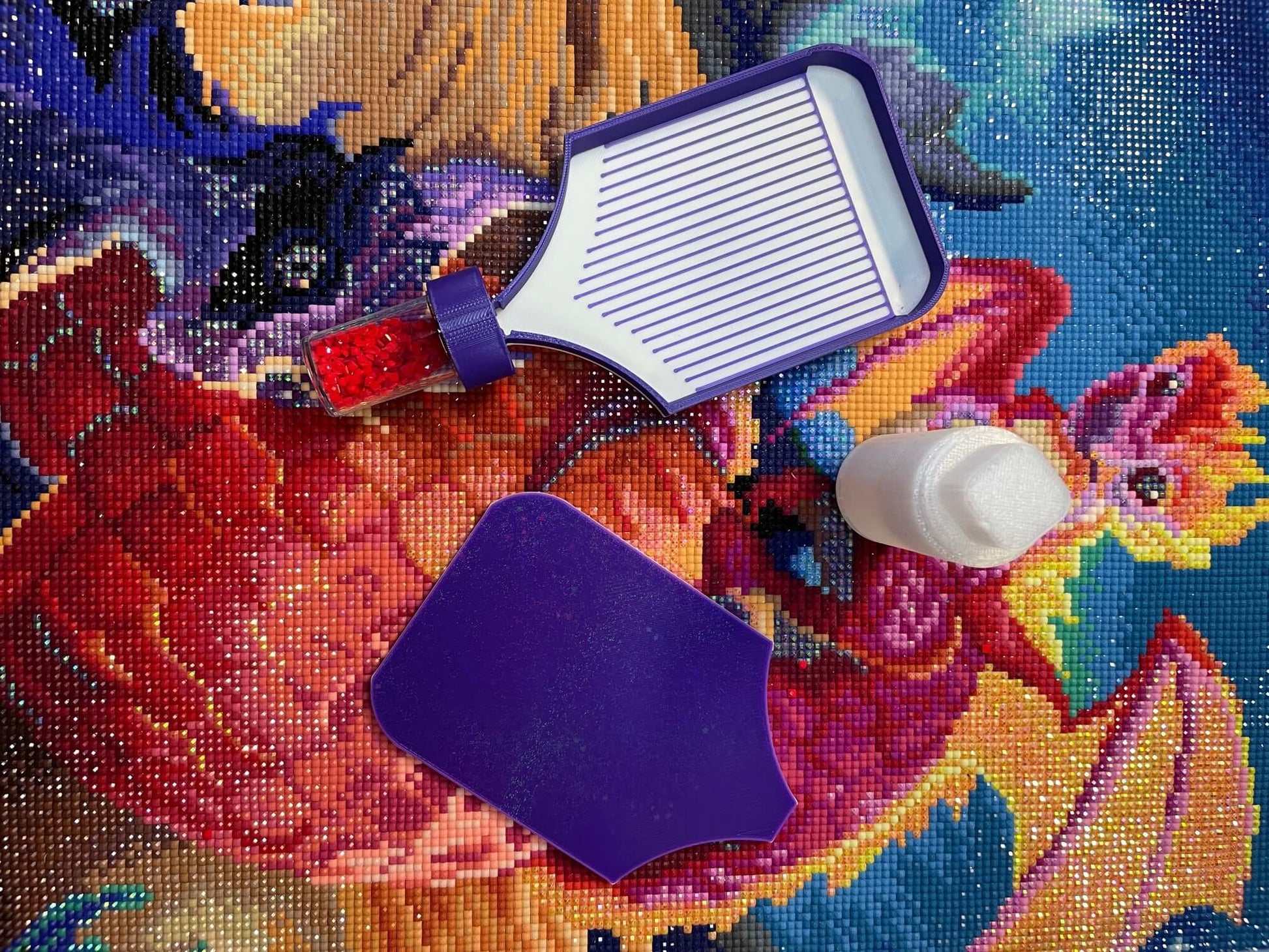 Purple and white Dragonling Screw & Shake diamond art tray with detachable base on colorful background