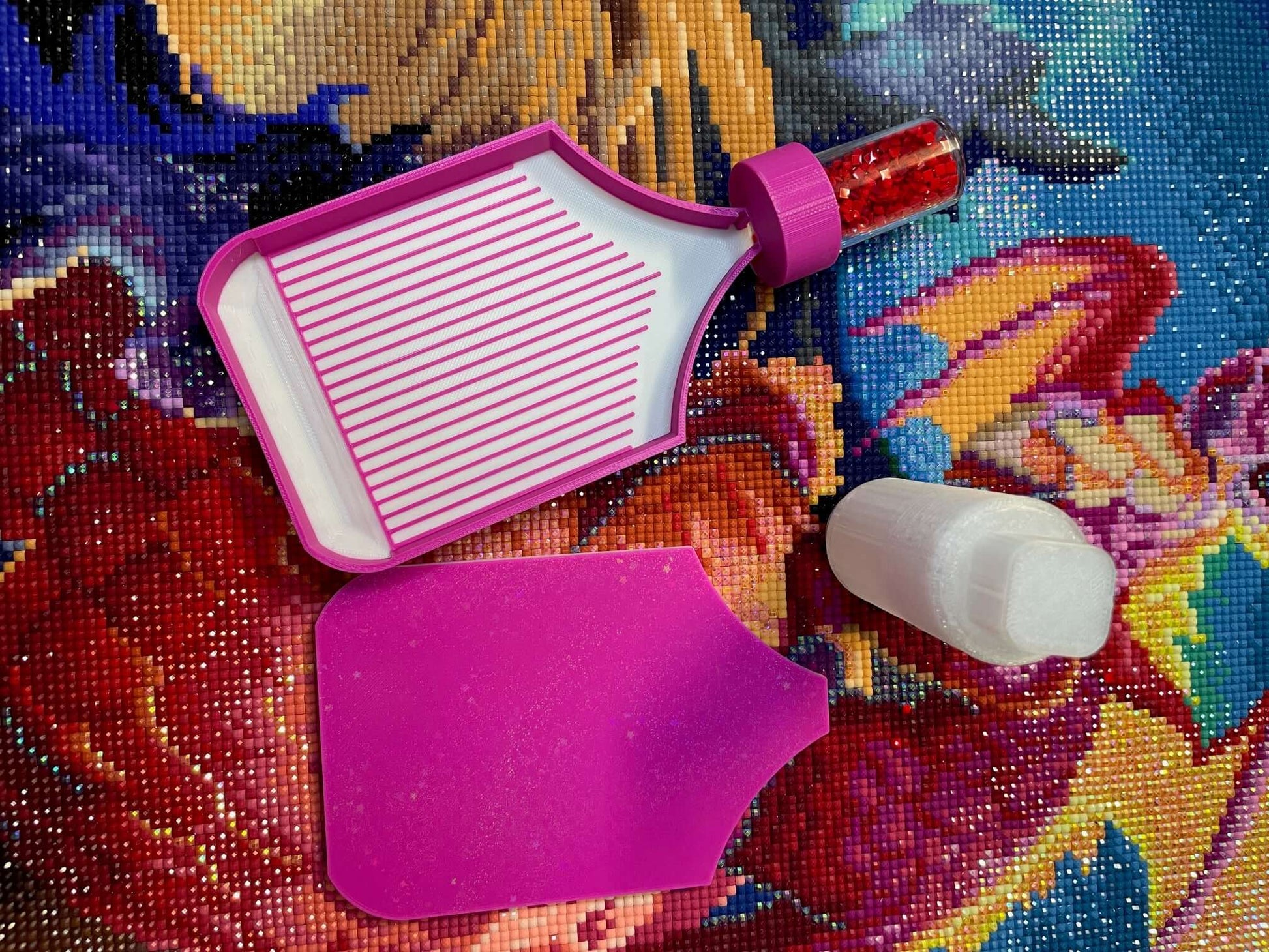Dragonling Screw & Shake White Belly Diamond Art Tray with pink edge on colorful canvas background.